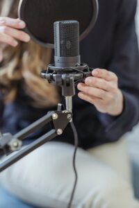 A Person Holding a Condenser Microphone